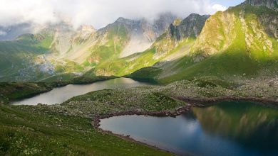 glacial lake beneath steep mountain peaks